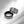 Two metallic rings with checkered pattern on a white surface