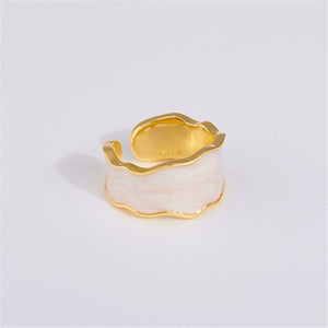 A set of three cocktail rings with gold plating and multicolored enamel, displayed against a white background.
