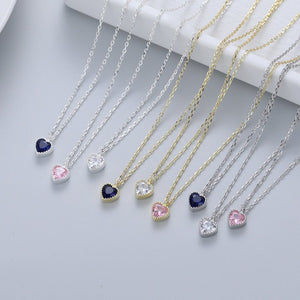 Necklaces with heart-shaped gemstones on a light gray background