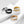 Four rings in gold, silver, black, and rose gold on a white background