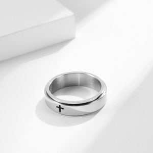 A collection of four rings, two with a black finish and two with a gold plating. Each ring features a cross symbol on the top surface.