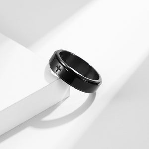 A collection of four rings, two with a black finish and two with a gold plating. Each ring features a cross symbol on the top surface.
