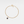 Gold bracelet with a blue gemstone on a light gray background