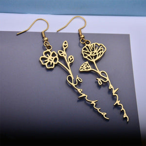 A pair of gold-plated stainless steel drop earrings designed as a rose and flower arrangement, displayed against a white background.