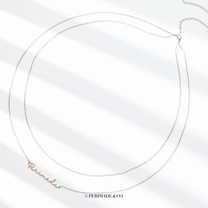 A close-up image of a person wearing a gold-colored double chain belly chain with customizable text.