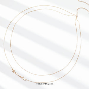 A close-up image of a person wearing a gold-colored double chain belly chain with customizable text.
