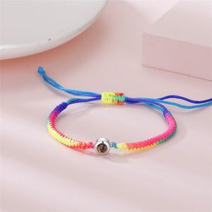 Three sterling silver rope chain bracelets with gold plating, adjustable closures, and colorful accents displayed on a flat surface.