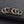 Set of six rings in various colors on a black textured surface
