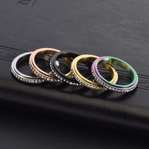 Set of six rings in various colors on a black textured surface