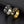 Two rings with star designs on a black textured surface