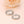 Two silver rings with 'You are my sunshine' engraving on a soft peach background with a rose.