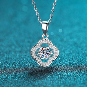 Silver necklace with a diamond pendant on a blue glittery background