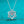 Silver necklace with a diamond pendant on a turquoise background