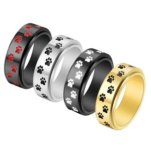 Four rings with paw print designs in different colors on a white background