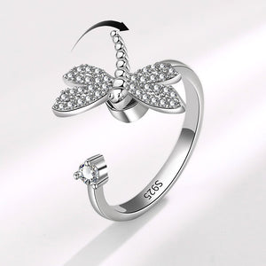 Silver butterfly ring with gemstones on a light gray background