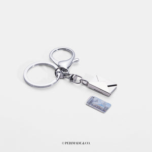 Silver keychain with silver letter and envelope charm on a white background, branded 'PERIMADE & CO'.