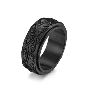 Black evil eye spinner band ring on a white surface