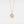 Gold necklace with a pendant on a light gray background