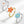 Three flower-shaped rings in silver, gold, and silver with blue and yellow centers on a white background.