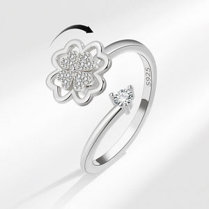 Silver ring with a four-leaf clover design on a light gray background