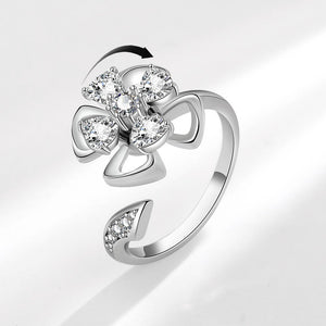 Silver ring with diamond accents on a light gray background