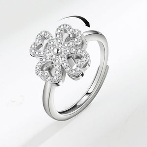 Silver ring with a floral design on a light gray background
