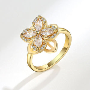 Gold ring with diamond-like stones on a white background