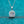 Silver necklace with a diamond pendant on a teal background