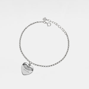 Silver bracelet with a heart-shaped locket on a light gray background