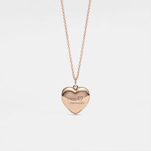 Rose gold heart-shaped locket necklace on a light gray background