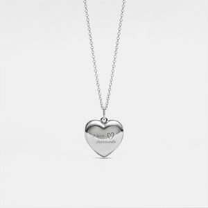 Silver heart-shaped locket necklace on a light gray background