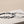 Two bracelets with infinity symbol designs on a beige surface