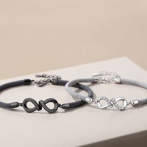 Two bracelets with infinity symbol designs on a beige surface