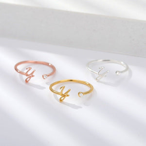 Three open gold rings with 'Y' lettering on a white background