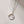Silver necklace with the fox pendant on a light background
