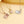 Three openable photo lock pendants on gold, silver and rose gold chains against a beige background