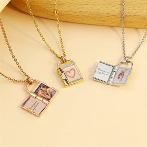 Three openable photo lock pendants on gold, silver and rose gold chains against a beige background