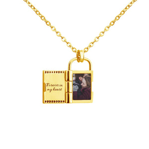 Gold openable photo lock pendant on a chain on a white background