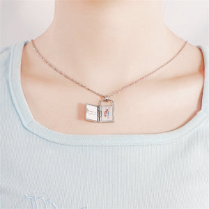 Model wearing a silver openable photo lock pendant shown open on a white background