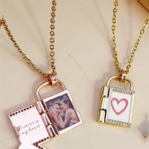 Two openable photo lock pendants on gold and rose gold chains against a beige background