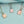 Three openable photo lock pendants on gold, silver and rose gold chains against a blue background