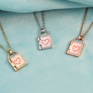 Three openable photo lock pendants on gold, silver and rose gold chains against a blue background