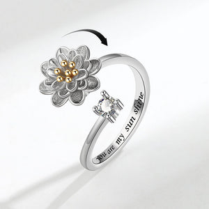 Silver ring with floral design and 'You are my sunshine' engraving on a white background