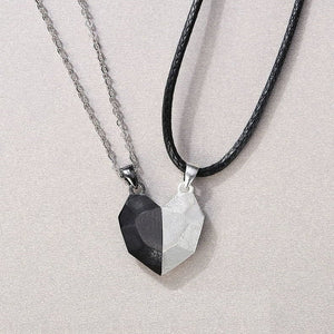 Two necklaces with geometric pendants on a light gray background