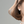 Model wearing square hoop earrings on a light gray background