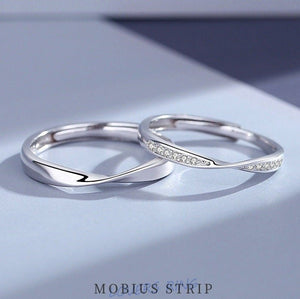 Two silver rings on a light blue background with 'MOBIUS STRIP' branding.