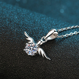Silver necklace with a diamond pendant on a textured black surface