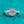 Diamond ring with pink and gold accents on a teal background