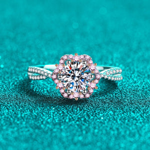 Diamond ring with pink and gold accents on a teal background
