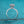 Silver diamond ring on a teal glittery background